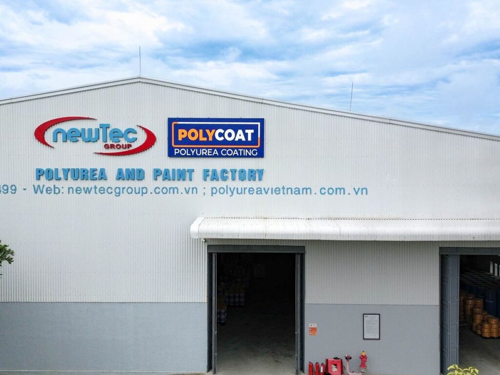 Industrial building with signage for a polyurea and paint factory.